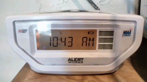 digital clock sitting on top of a counter top
