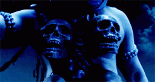 three large skulls sit behind a young woman