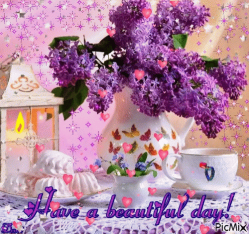 a purple flower arrangement and coffee cup on lace