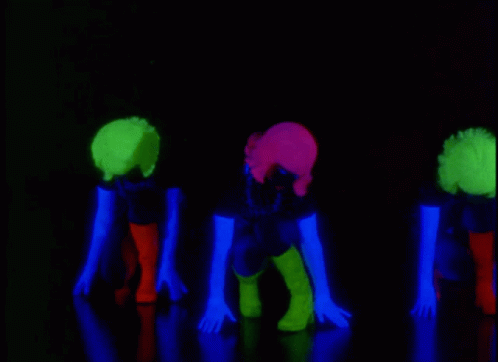 three people with glow hair are posing for the camera
