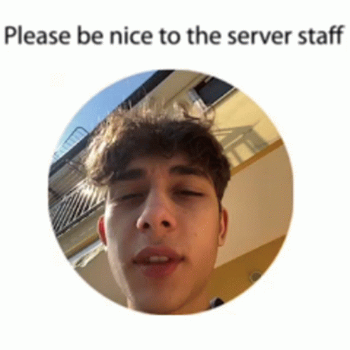 a man in an office is looking at the camera and is texting please be nice to the server staff