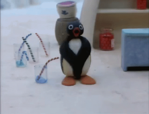 a penguin figure is next to some small objects