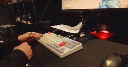 a man wearing a glove using a keyboard