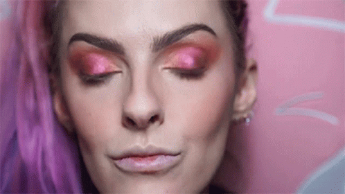 a girl wearing bright pink and purple eye makeup