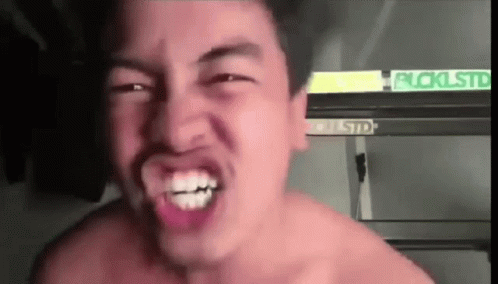 an ugly shirtless young man making funny face