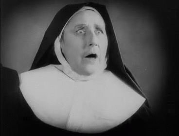 woman with surprised expression in nun costume