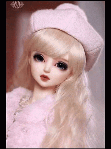a po of a young doll wearing a white dress and a blue hat