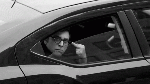man in a car, smoking on his cigarette