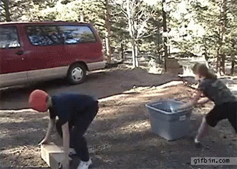 three people are making a sand pail outside