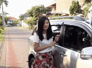 a person stands next to a car