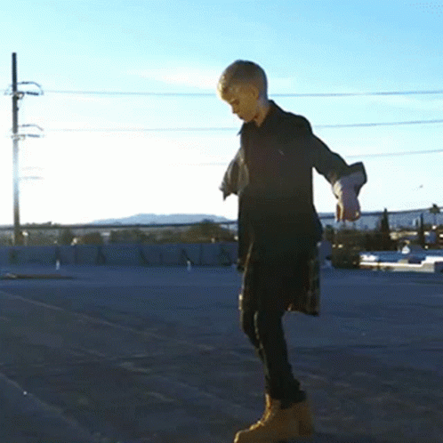 a boy wearing a protective gear riding a skateboard