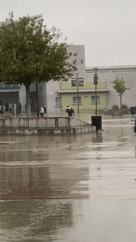 people walking in the rain on the street and on the sidewalk