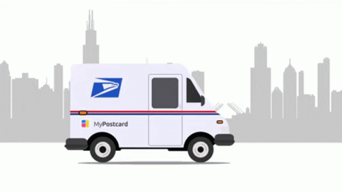an postal service truck parked in front of a city