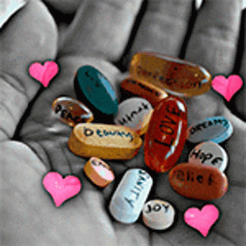 a group of pills with their name written on them in the palm of someones hand