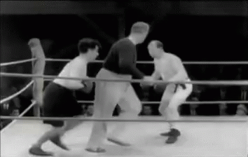 several men standing inside of a boxing ring