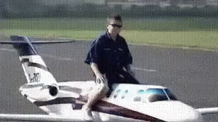 a man is stepping into the front of an airplane