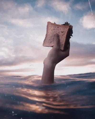 an old person is floating in a body of water holding a sponge