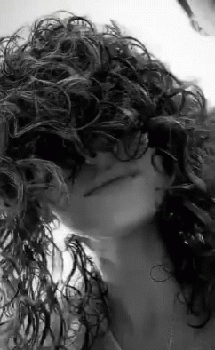 a close up of a woman with lots of hair