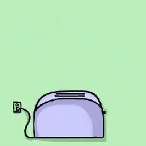 a pink toaster sitting on top of a green surface