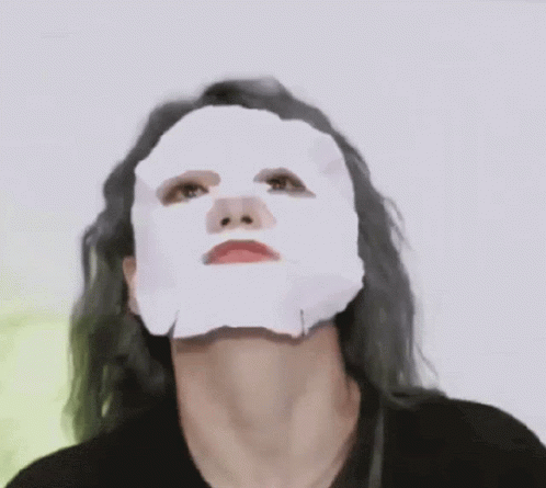 a woman wearing a white mask over her face