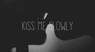 the words kiss me slowly in a dark room