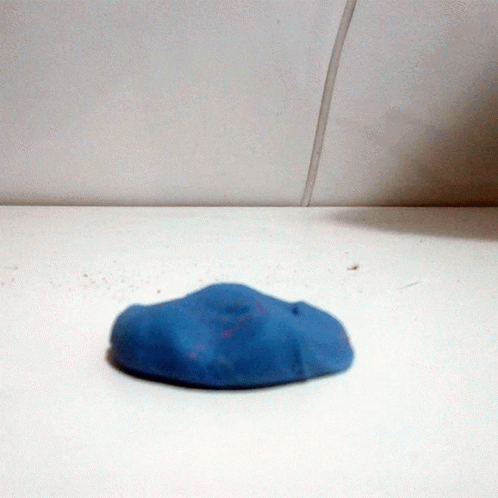 a piece of pottery sitting on top of a white surface