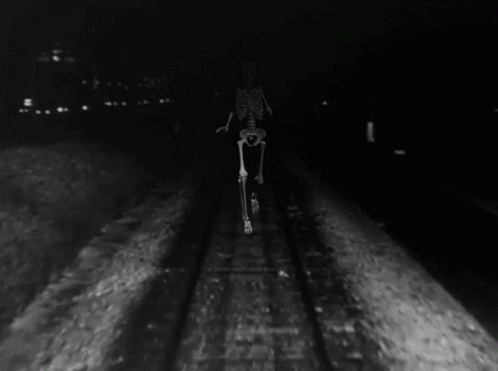a man riding a bike down a train track
