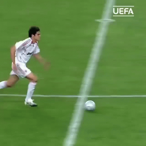 a man on a field with a soccer ball