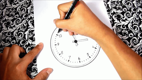 a man is drawing a clock with blue chalk