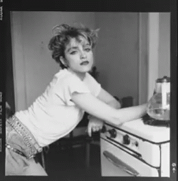 a black and white po of a woman in front of a stove