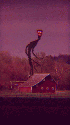a weird thing on a building next to a barn