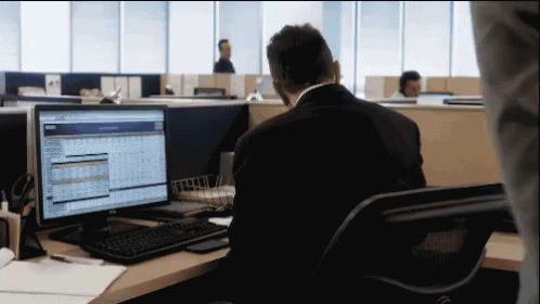 this person looks at a computer monitor while he sits in his office