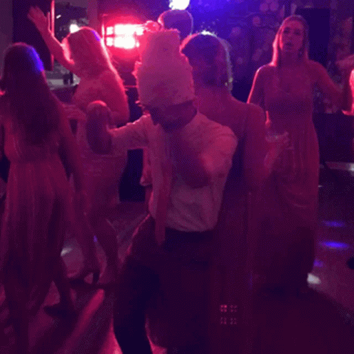 a group of people dancing together at a club
