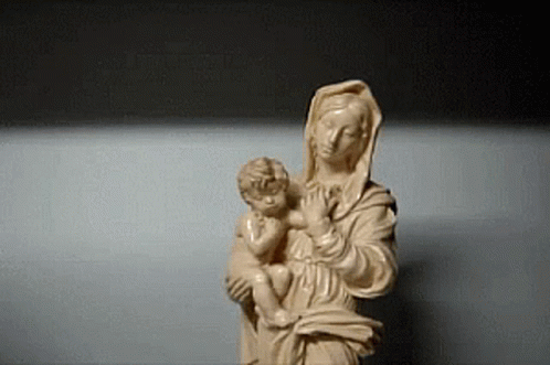 a small statue of the virgin mary holding a child