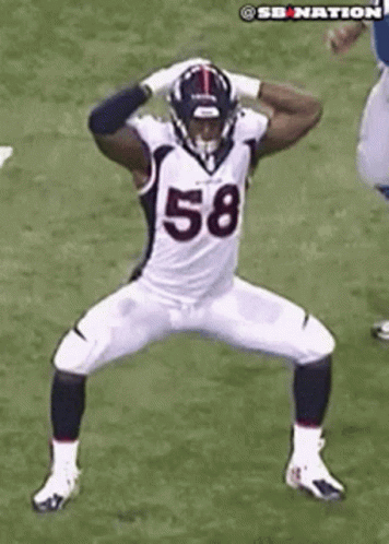 a football player in the process of taking a swing with his head