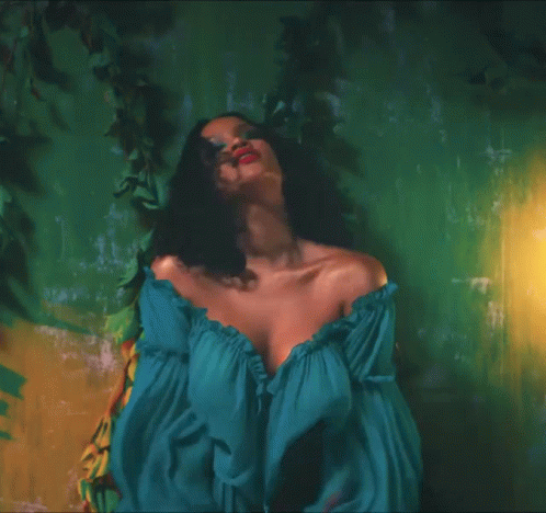 a woman in an off the shoulder dress, in green and blue