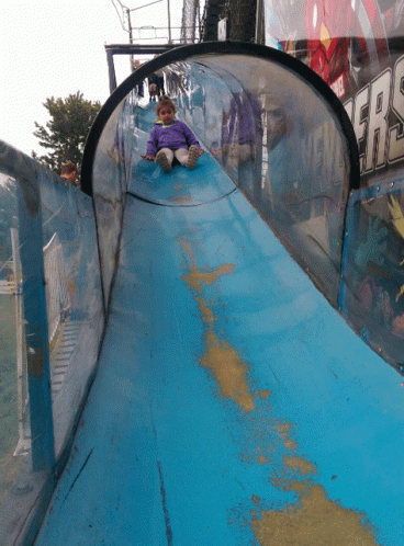 a close up of a slide with a person sitting on it