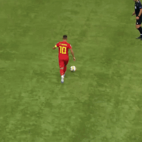 soccer player running with a ball at full speed