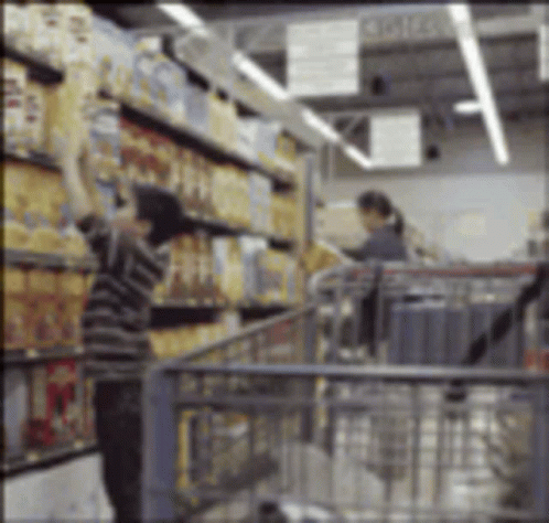 blurry pograph of people shopping in a grocery store