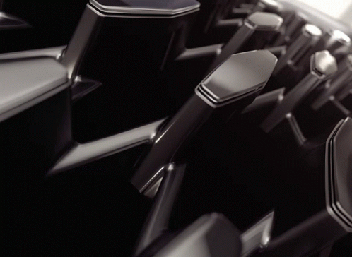 a row of black and silver chairs with chrome handles