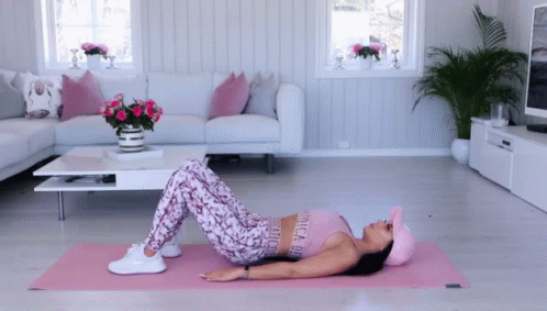 a woman on the floor doing yoga in her living room