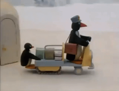 two black figurines with boxes in them on a cart