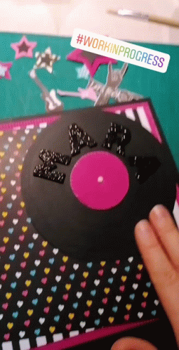 person pointing to records on a table with confetti