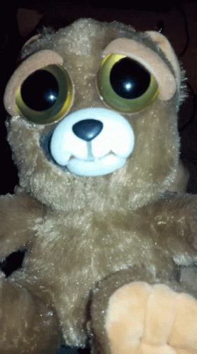 a blue teddy bear with big eyes and big ears
