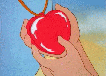 a cartoon drawing of a purple apple being held by someone