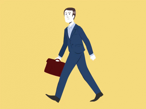 a man in suit and tie walking with a briefcase