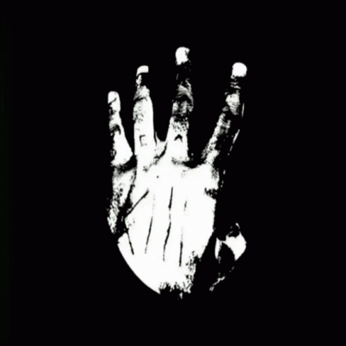 a black hand with one hand is seen against a dark background