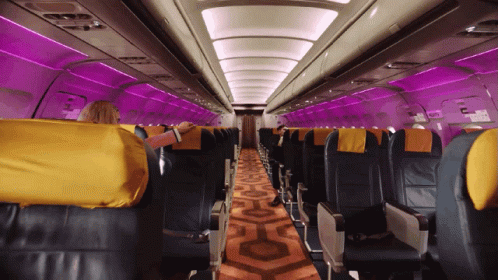 the inside of an airplane has been lit up with purple lighting