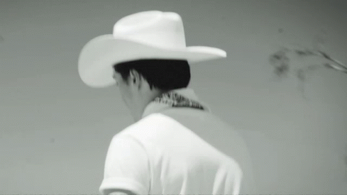 the back of a man's head wearing a white cowboy hat