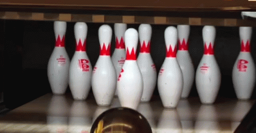 the bowling pins are lined up on the ground